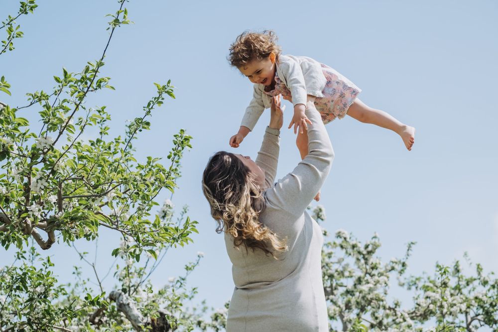 Mother tossing daughter during Annapolis Valley family photo session.