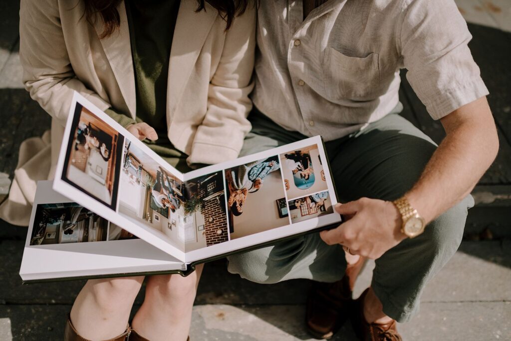 Couple looking at photos in printed wedding album.