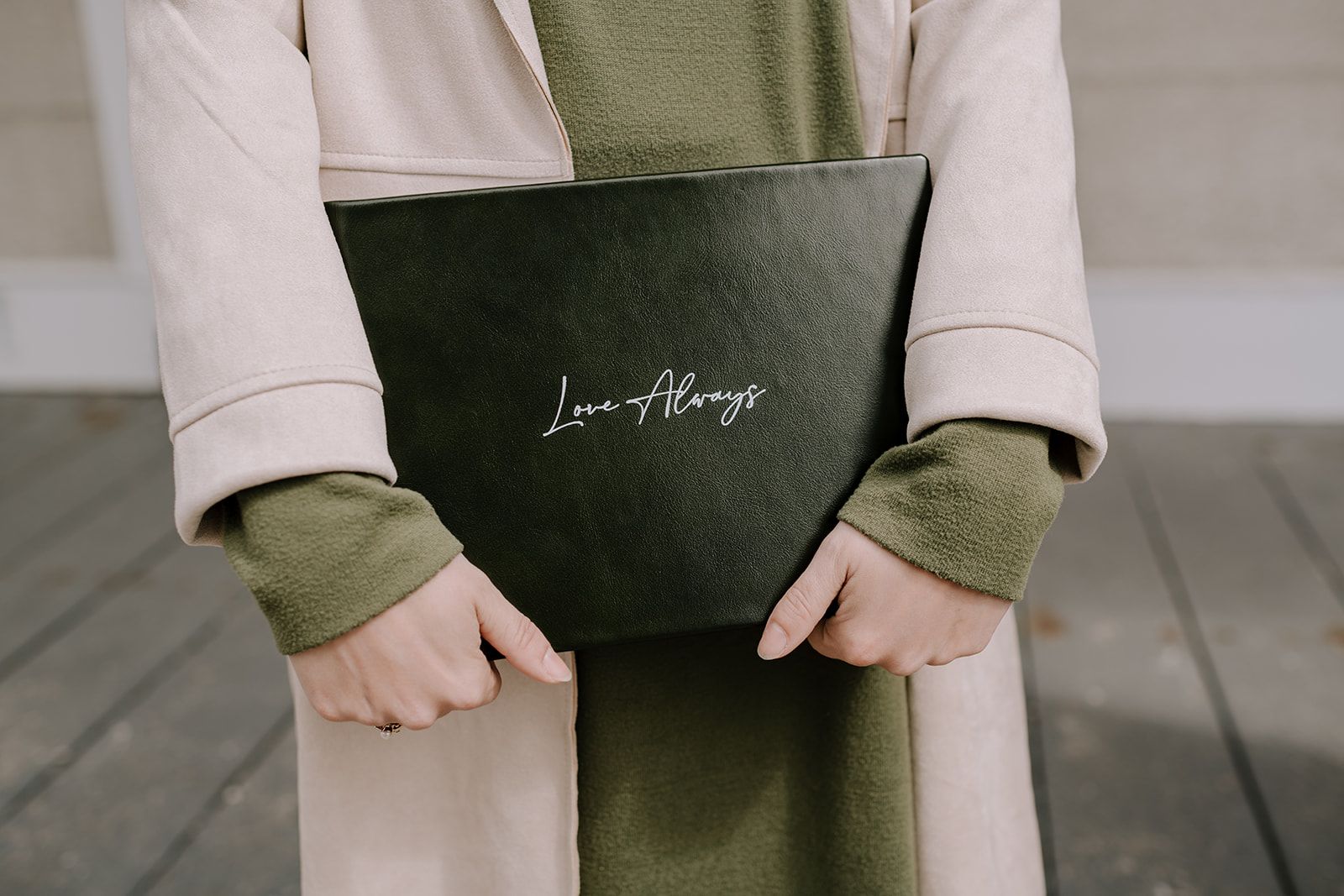 Woman holding wedding album.